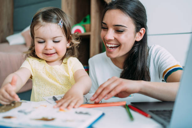 istock Mother and daughter working at home. 1406495119