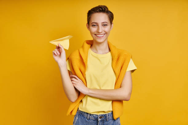 istock autiful young woman holding paper airplane 1406496718