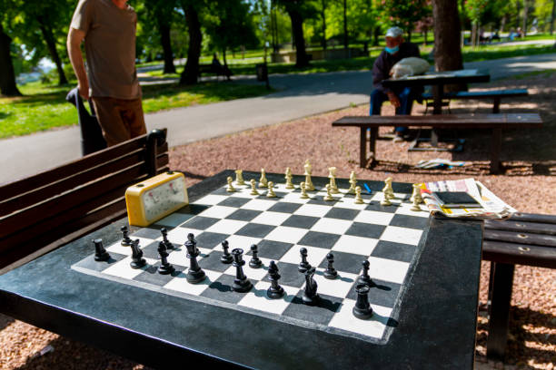 istock Chess pieces and stopwatch on a board in the park. 1406496819