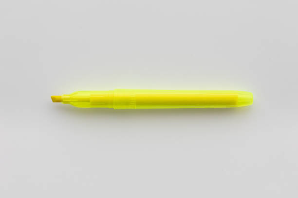 The development of the fountain pen. Set of various pens closeup on yellow paper background