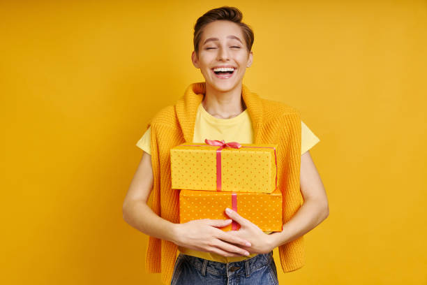 istock Happy young woman carrying gift box 1406497558