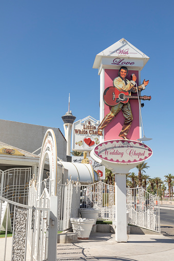 Las Vegas, USA - May 24, 2022:    sign wedding chapel with picture of Elvis Presley and the little white chapel in background for fast marriages.