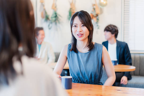 istock Two women talking in a cafe 1406500660