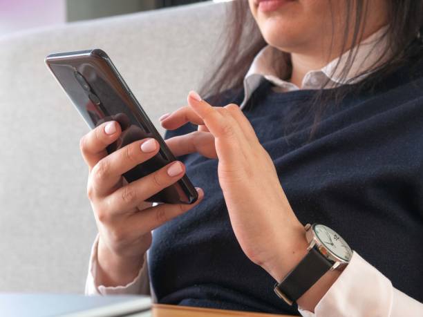 istock A young woman's hands are holding a smartphone or typing a text 1406500664