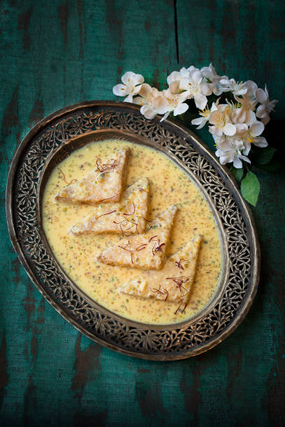 Shahi tukra or double meetha served in dish isolated on dark background top view