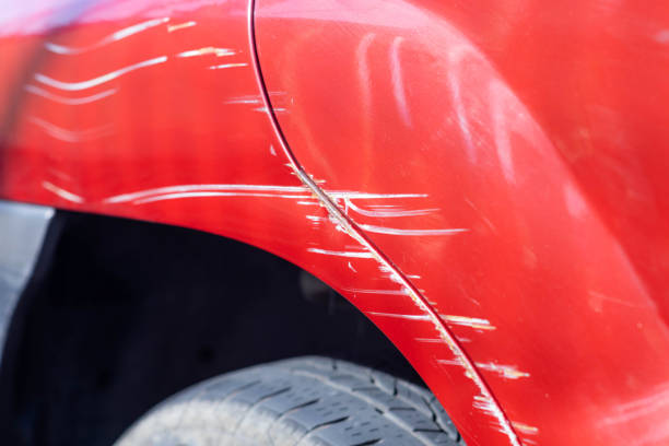 istock Scratches on the side of a red car. 1406503860