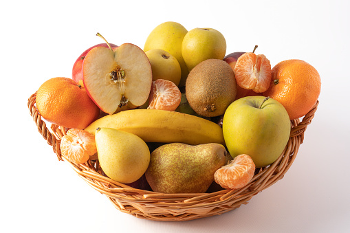 Nice wicker basket full of fresh and varied fruit