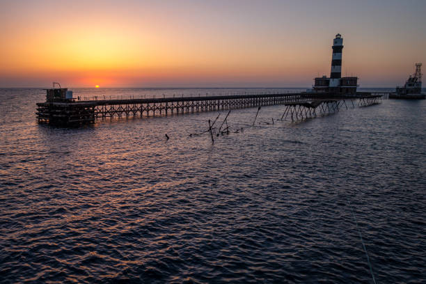 podersdorf neusiedlersee sunset in austria with lighthouse at twilight, lake and blurred water due to long exposure