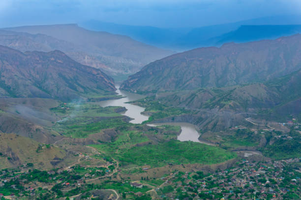 foggy mountain valley with river, villages and fields