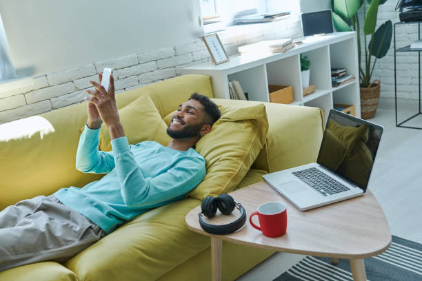 istock Cheerful African man using smart phone 1406509040