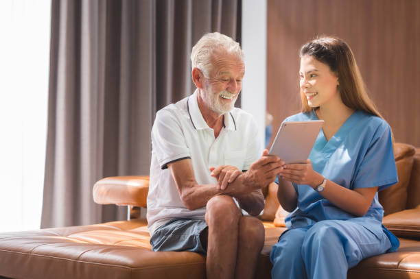 istock nurse  teaching senior to use tablet 1406509289
