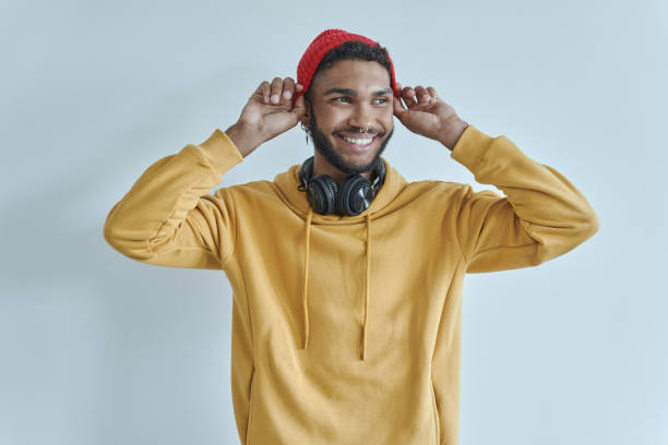 istock Handsome African man adjusting his hat and smiling 1406509398