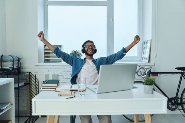 istock Excited young African man in headphones gesturing 1406511562