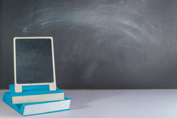istock Blue books and Mini blackboard placed on the table, Blackboard as a backdrop, Copy-space 1406512517