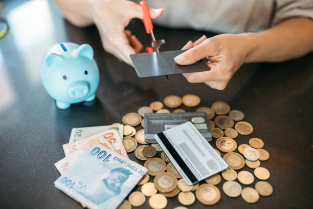 istock Woman cutting credit card for avoiding overspending 1406512619