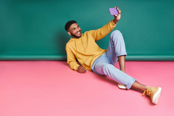 istock Happy African man making selfie by smart phone 1406512917