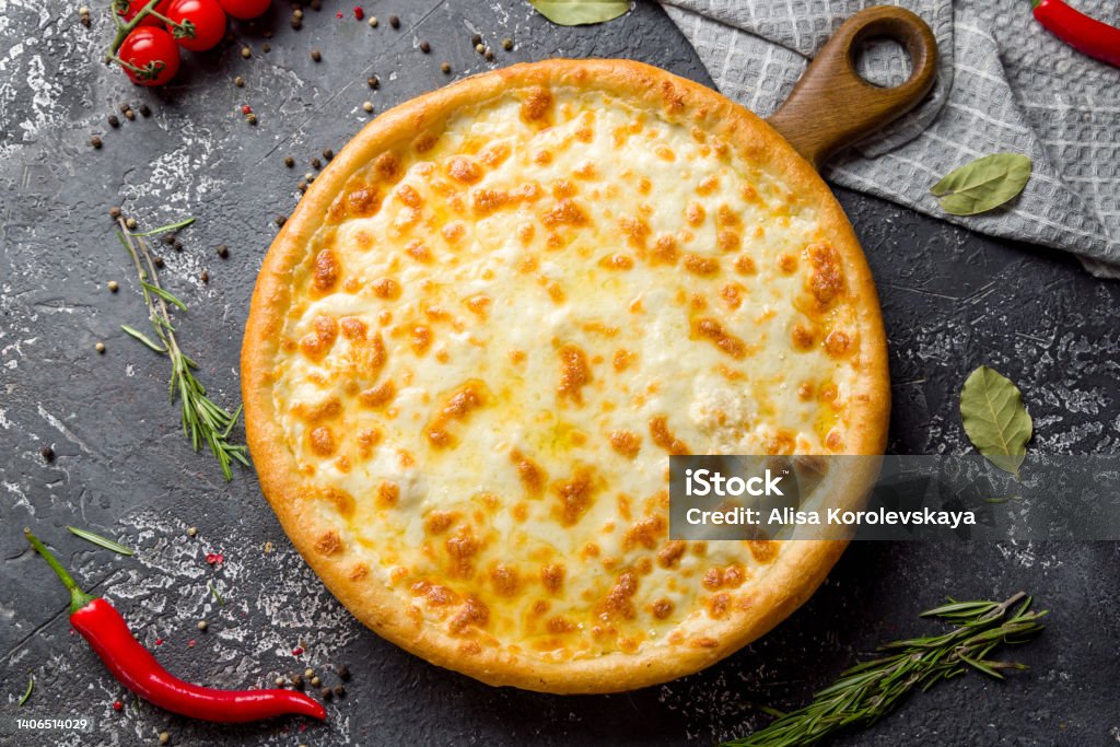 Cheese pizza on board on dark stone table top view Pizza Margherita Stock Photo