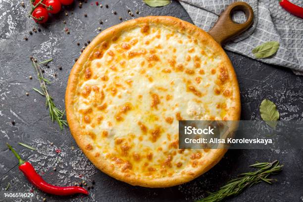 Cheese Pizza On Board On Dark Stone Table Top View Stock Photo - Download Image Now - Pizza Margherita, High Angle View, Pizza