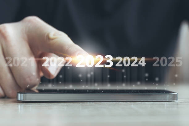 istock New year 2023 concept. finger touching abstract display with time change 1406514132