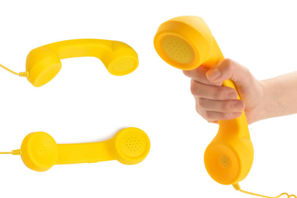 istock Yellow handset in woman hand isolated on white. 1406514430