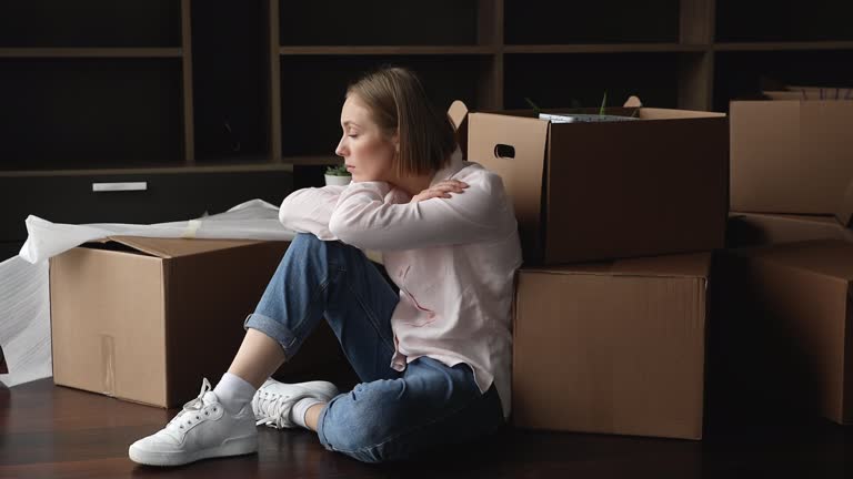Frustrated young renter girl moving out from apartment