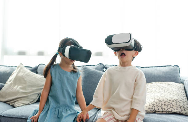 istock Asian child feeling excited while using 360 VR headset for virtual reality, Metaverse at home. 1406519329