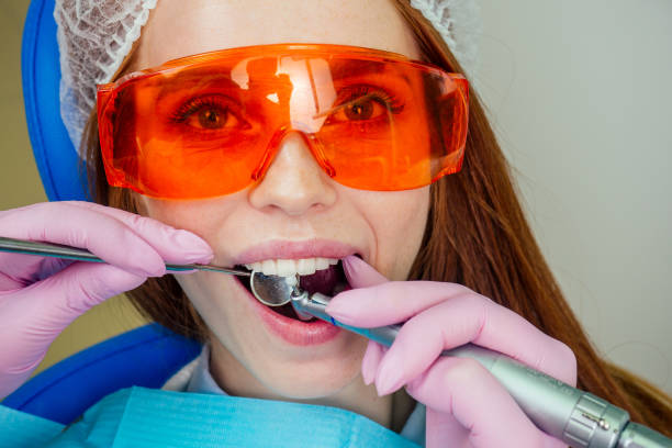 istock Dental drilling procedure and check up on beautiful teeth and open mouth 1406519412