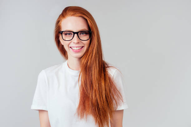 istock redhaired ginger woman wear glasses in white studio 1406519459