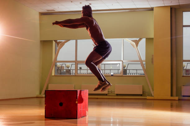 istock afro man doing exercise with a fit box in a gym 1406519600