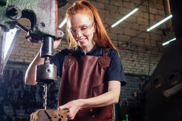 istock redhead ginger woman working smithytools in dark workplace forging hammering malleation details. small business concept 1406519669