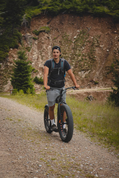 istock Swarthier type of person rides a downhill mountain scooter on a steep forest path around a mountain in Jeseniky mountains, czech republic. Dolni Morava resort 1406520056