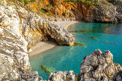 Paradise empty beach with no people and turquoise sea named Cala Capreria at the natural reserve Riserva dello Zingaro, Scopello, Sicily, Mediterranean Sea, Italy.