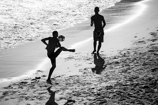 Salvador, Bahia, Brazil - November 01, 2021: People playing beach soccer at Paciencia beach in Rio Vermelho neighborhood in Salvador, Bahia.