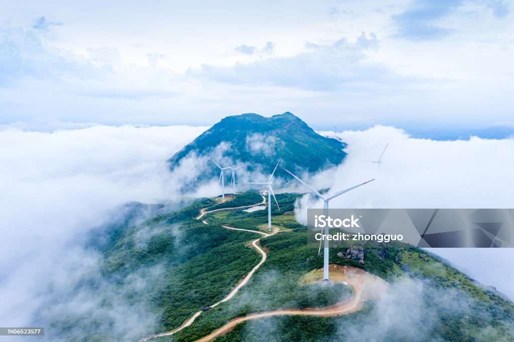 High mountains, sea of clouds and wind turbines Large areas of wind power in the mountains Sustainable Resources Stock Photo