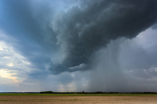 istock Storm clouds over field, downburst of rain, dangerous storm 1406523874