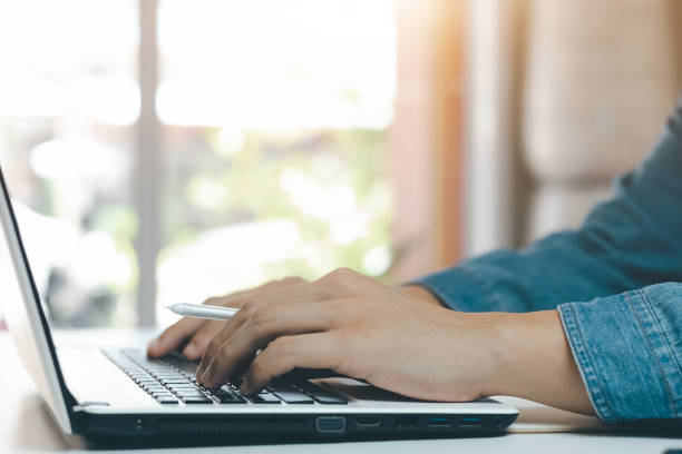 istock young man using laptop computer and mobile phone When looking for financial information in business. 1406524732
