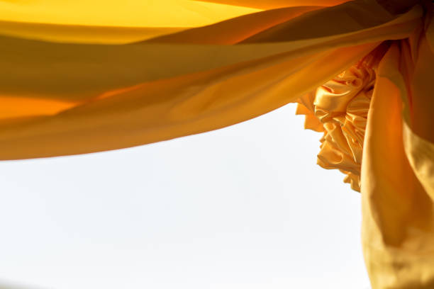 istock Yellow sateen rolls and hanging to decorate the arch 1406527366