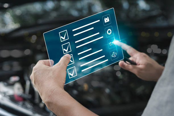 Car business concept and technology on virtual screen, Serviceman check service list on-screen icon of car mileage for maintenance and service with the engine room in the background, Smart work of car