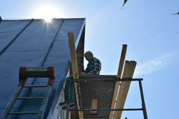 istock Mason works on thermal insulation of the wall with polystyrene 1406527543