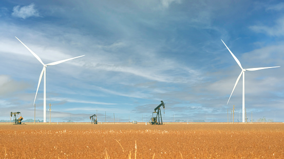 Wind Turbines and Oil rig Pump Jack rigs in the Texas desert.