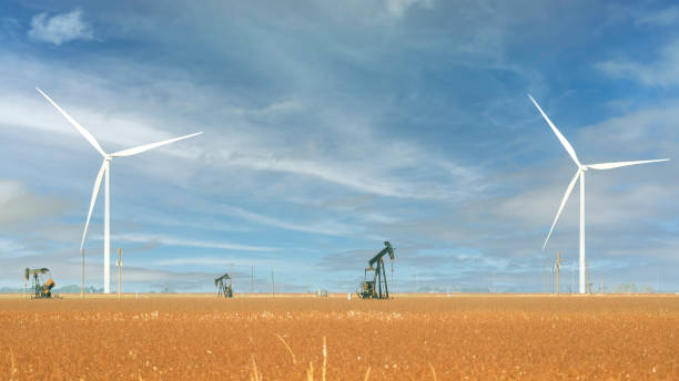 Wind Turbines and Oil rig Pump Jack rigs in the Texas desert. stock photo
