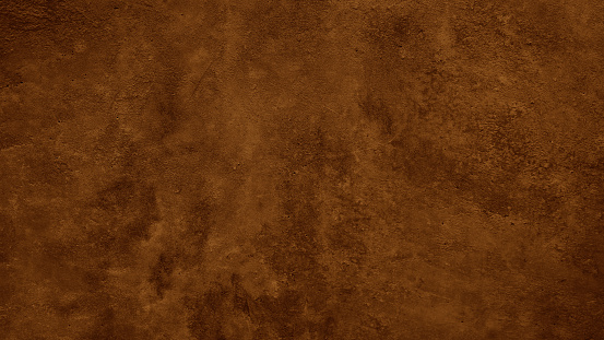 Textura rugosa de color marrón oscuro. Superficie de muro de hormigón tonificado. Primer plano. Fondo marrón con espacio para el diseño. photo