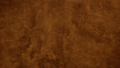 istock Dark brown rough texture. Toned concrete wall surface. Close-up. Brown background with space for design. 1406528811