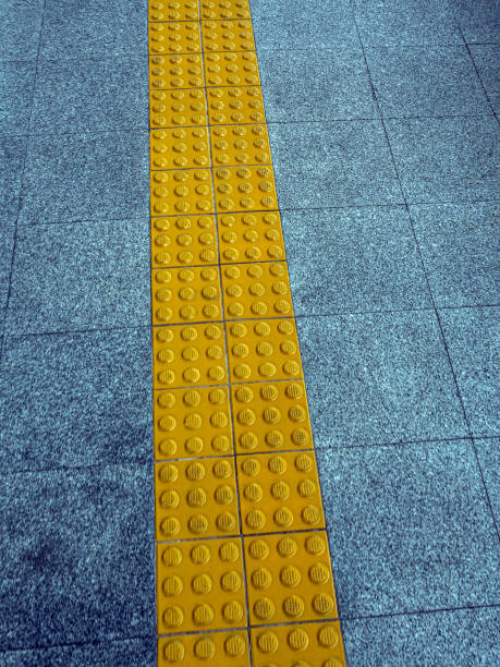 istock The yellow pavement has a textured surface to serve as a walking guide for the visually impaired 1406528834