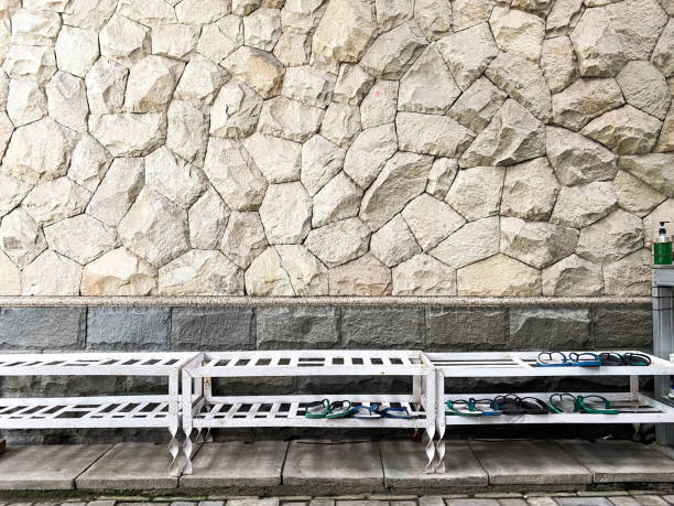 istock shoe rack in front of a white natural stone wall 1406530261