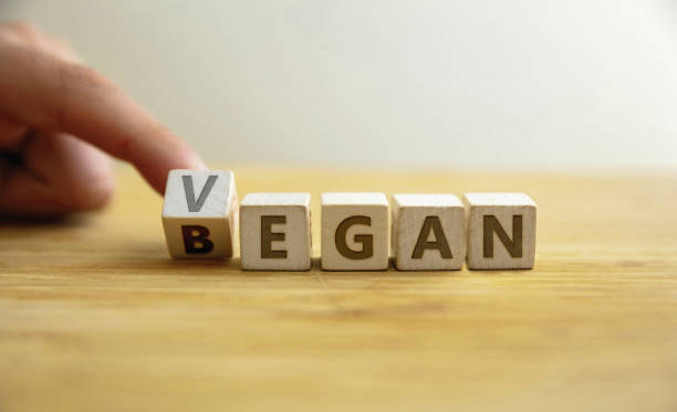 began vegan lifestyle concept. finger flips letter at wooden cube changing the word began to vegan. - organic single word environment block imagens e fotografias de stock