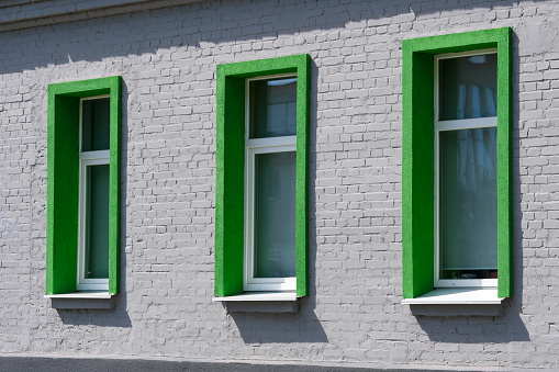 Windows of a weathered townhouse, Germany.