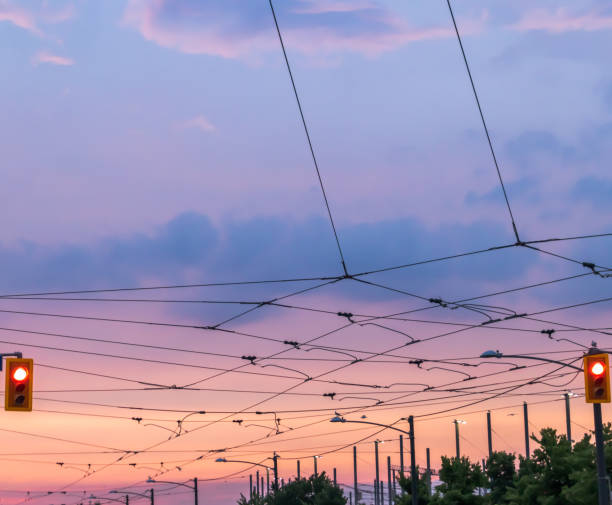 Overhead wires of urban streetcar system at dusk Overhead wires of urban streetcar system at dusk. Grid pattern. Green energy concept. sustainable energy toronto stock pictures, royalty-free photos & images