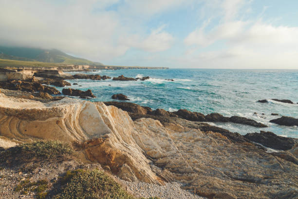 Rocky cliffs on the beach and dramatic ocean view in Montana de Oro State Park, Los Osos, California Central Coast