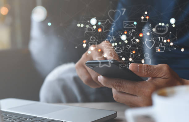 istock Man using mobile phone at home with social media apps icons on virtual screen, social media, digital marketing 1406541743
